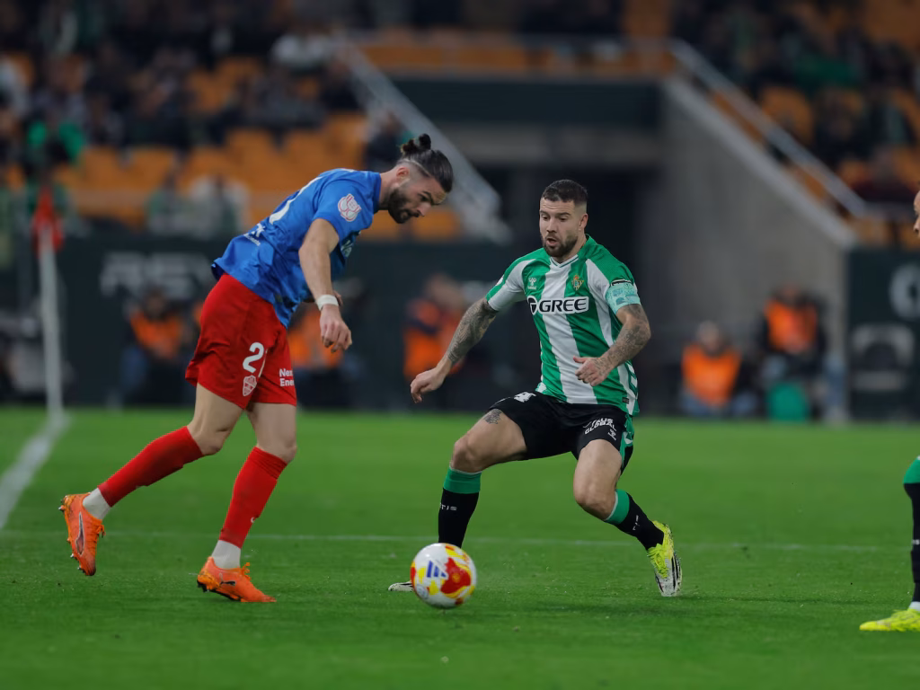 Aitor Ruibal (Betis) presiona la salida de balón  de Leo Petrót (Elche) en el partido que medía a ambos conjuntos en los octavos de final de la Copa del Rey.